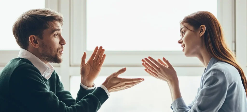 man discussing something in with woman