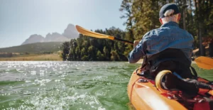 Retired man relaxing and boating in lake